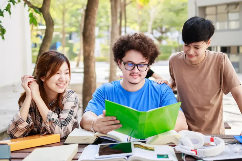 Asian teens studying O-level Maths outdoors