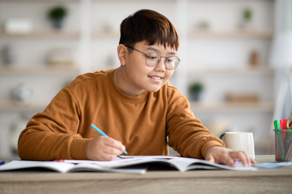 teenage boy studying indoors