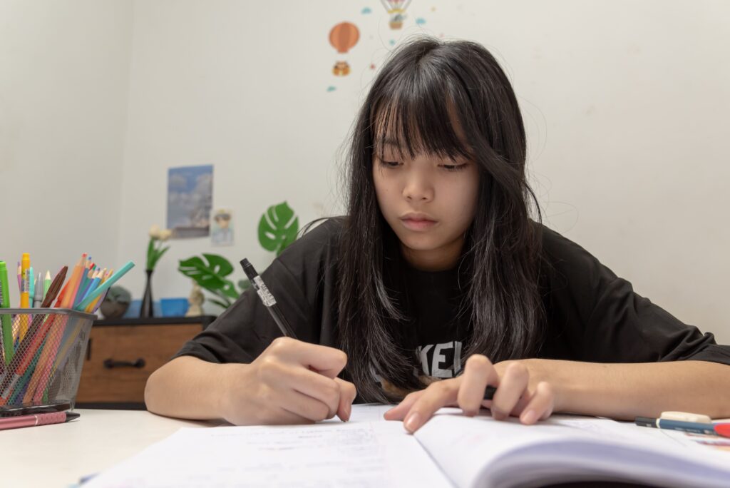Secondary school student working through A-Math practice questions to identify and correct recurring mistakes before examinations.